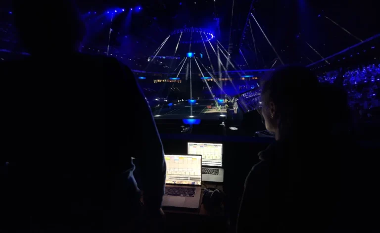 Sound engineers controlling live audio during sports event with immersive sonic identity experience